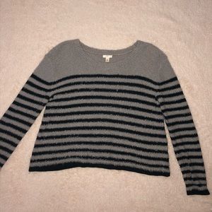 woman’s striped black and grey sweater